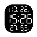 Cavira LED acrylic smart wall clock with digital display, thermometer, alarm, countdown, and night light in a modern living room setting
