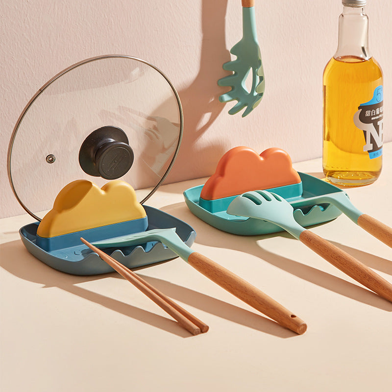 Cavira multi-slot kitchen utensil and lid organiser rack holding pot lids, spatulas, and chopping boards on a countertop.