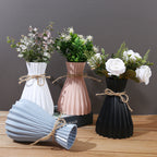 Minimalist folded paper vase by Cavira with twine detail, designed for creative plastic flower arrangements and home decor.