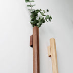 Solid wood wall hanging vase with glass insert by Cavira, ideal for hydroponic flowers and wall decor in living room or bedroom.