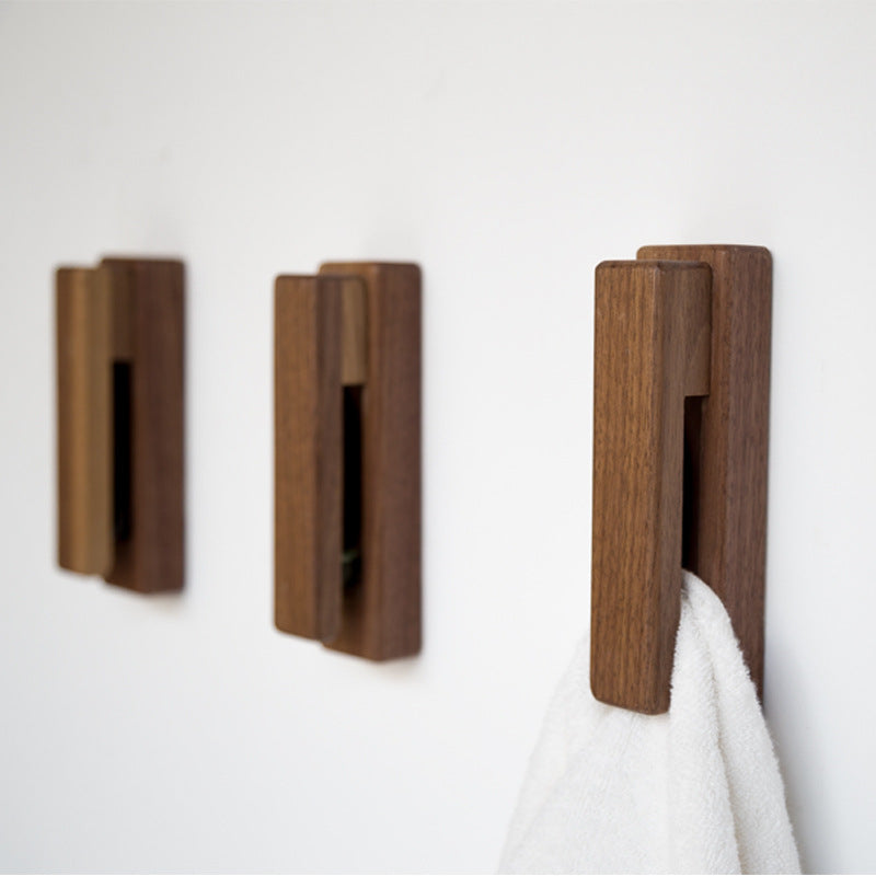 Black walnut and eucalyptus adhesive wooden single hook by Cavira, no-drill, ideal for bathroom, entryway, or bedroom, supports 2kg load.