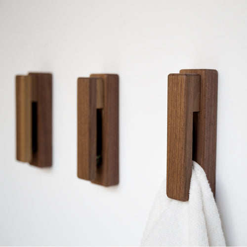 Black walnut and eucalyptus adhesive wooden single hook by Cavira, no-drill, ideal for bathroom, entryway, or bedroom, supports 2kg load.