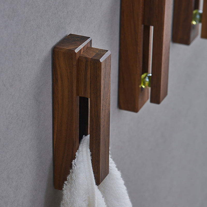 Black walnut and eucalyptus adhesive wooden single hook by Cavira, no-drill, suitable for bathroom, entryway, or bedroom, supports 2kg load.