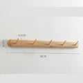 Beech wood baguette wall coat rack by Cavira with 2-5 hooks, suitable for entryway or hallway, supports 10kg load.