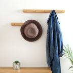 Beech wood baguette wall coat rack by Cavira with 2-5 hooks, ideal for entryways, hallways, and bedrooms, supports 10kg load