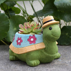 Eprolo turtle-shaped flower pot decoration for outdoor courtyard with vibrant plant arrangement and decorative stone accents.