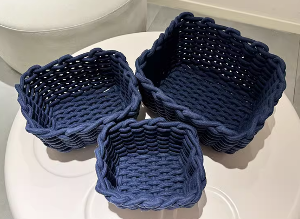 Set of three Cavira hand-woven cotton rope storage baskets in minimalist ink blue, nesting for living room, bedroom, or bathroom.