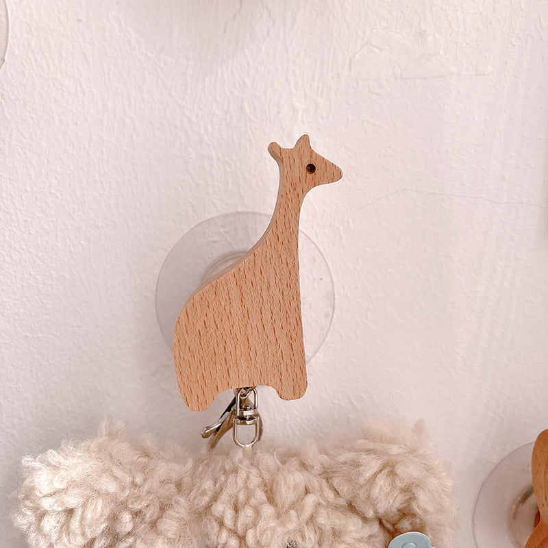 Wooden animal-shaped wall hooks by Cavira featuring giraffe, hippo, lion, rabbit, and elephant for kids' nursery or playroom decor.