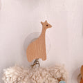 Wooden animal-shaped wall hooks by Cavira featuring giraffe, hippo, lion, rabbit, and elephant for kids' nursery or playroom decor.