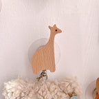 Wooden animal-shaped wall hooks by Cavira featuring giraffe, hippo, lion, rabbit, and elephant for kids' nursery or playroom decor.