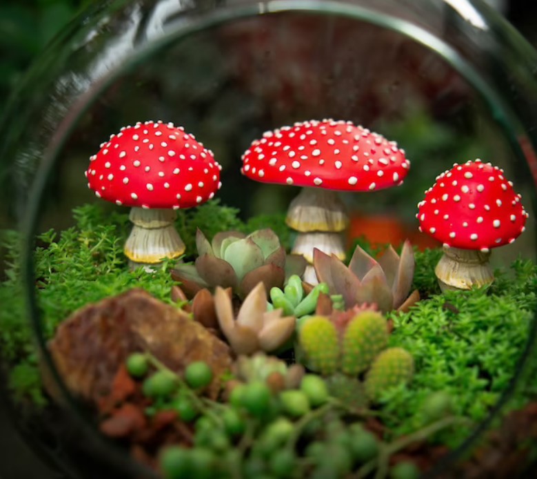Set of glow-in-the-dark resin mushroom garden ornaments by Cavira, whimsical fairy garden and outdoor patio décor accents.