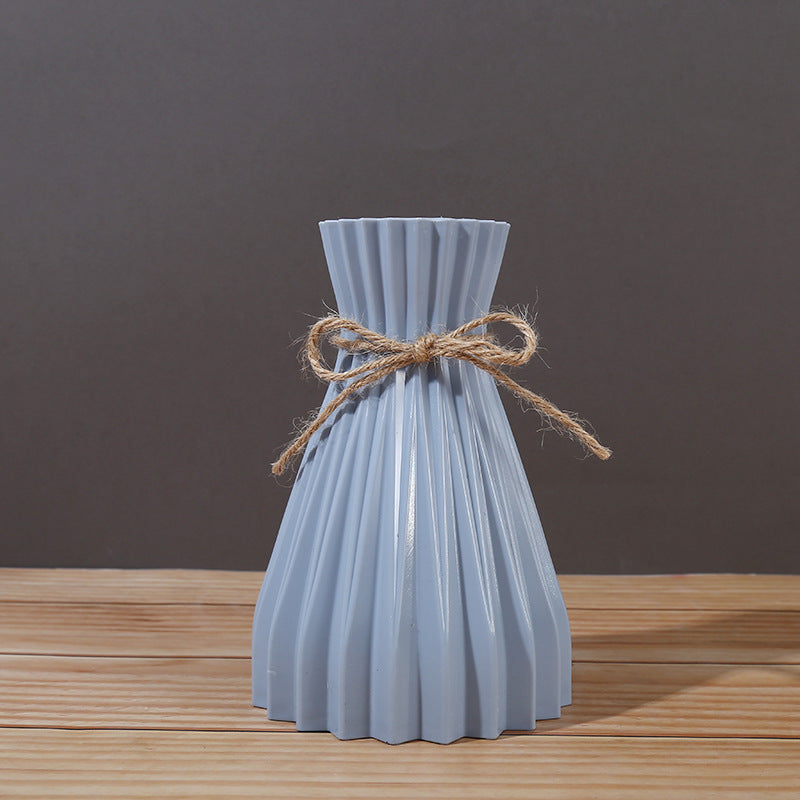 Minimalist Cavira folded paper vase with twine detail, designed for creative plastic flower arrangements and home decor.