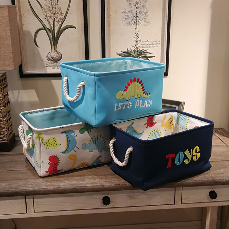 Canvas folding dinosaur storage basket by Cavira with embroidered cartoon dinosaur, ideal for kids' toys and stationery in nursery or bedroom