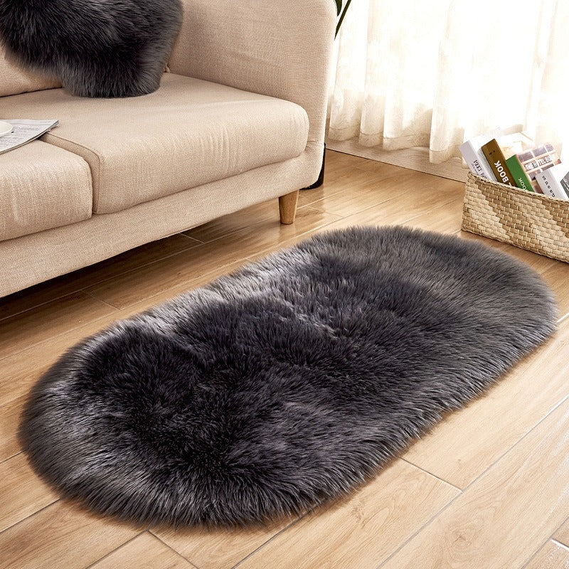 Oval acrylic plush rug by Cavira with soft wool-like pile in various sizes and colors, ideal for bedroom and living room decor.