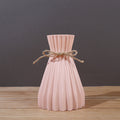 Minimalist paper vase with twine detail by Cavira, showcasing a creative plastic flower arrangement for home decor.
