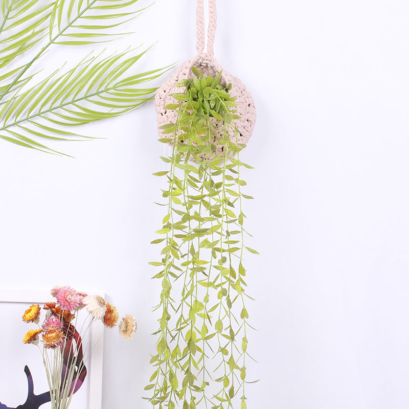 Handwoven boho cotton rope wall hanging net basket with woven flower design, ideal for home, bedroom, or living room storage.