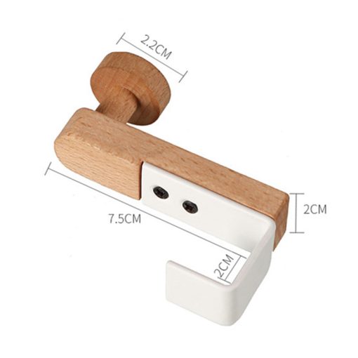 White iron and rubber wood wardrobe hook by Cavira, shown mounted on bedroom or cabinet furniture for hanging clothes or accessories.