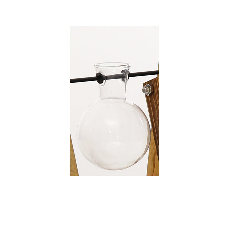 Cavira high borosilicate glass ball vase with retro wooden rack, used as a hydroponic planter or vintage desktop ornament.