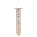 Handwoven cotton rope evil eye wall hanging tapestry with tassels and beech wood rod, perfect for boho bedroom or living room décor.