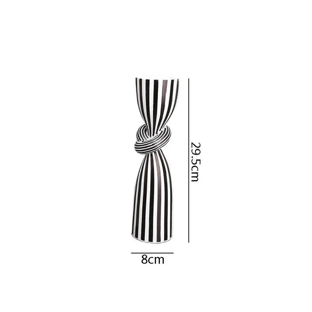 Black and white striped resin candle holder with modern irregular geometric design, ideal for home decor.