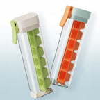 Large orange and green Cavira ice ball maker mold for creating slow-melt round ice spheres for whiskey and cocktails