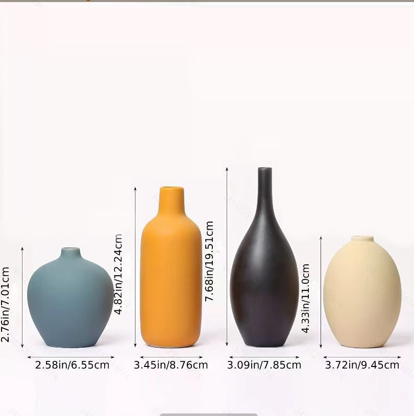 Set of four white porcelain ceramic vases by Cavira, modern minimalist design for floral arrangements and home decor.