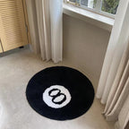 Black flocked square rug by Cavira, non-slip velvet-touch floor mat in 60, 80, or 100cm, suited for living rooms and bedrooms.