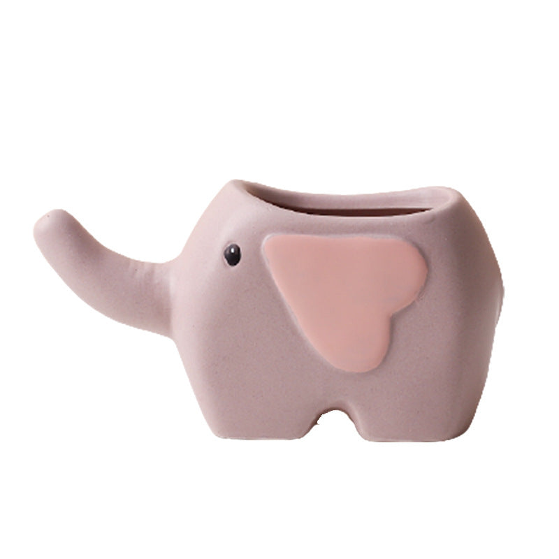 Cute ceramic succulent pot by Cavira featuring elephant, dinosaur, and flower designs, ideal for small desk or balcony plants.