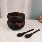 Handcrafted coconut shell bowl from eprolo with wooden utensils, ideal for breakfast, smoothies, or salads, eco-friendly and natural.