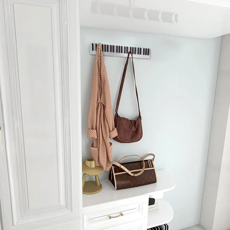 Wooden piano keyboard wall hook by Cavira, decorative wall decor in small, medium, and large sizes for entryways and music rooms.