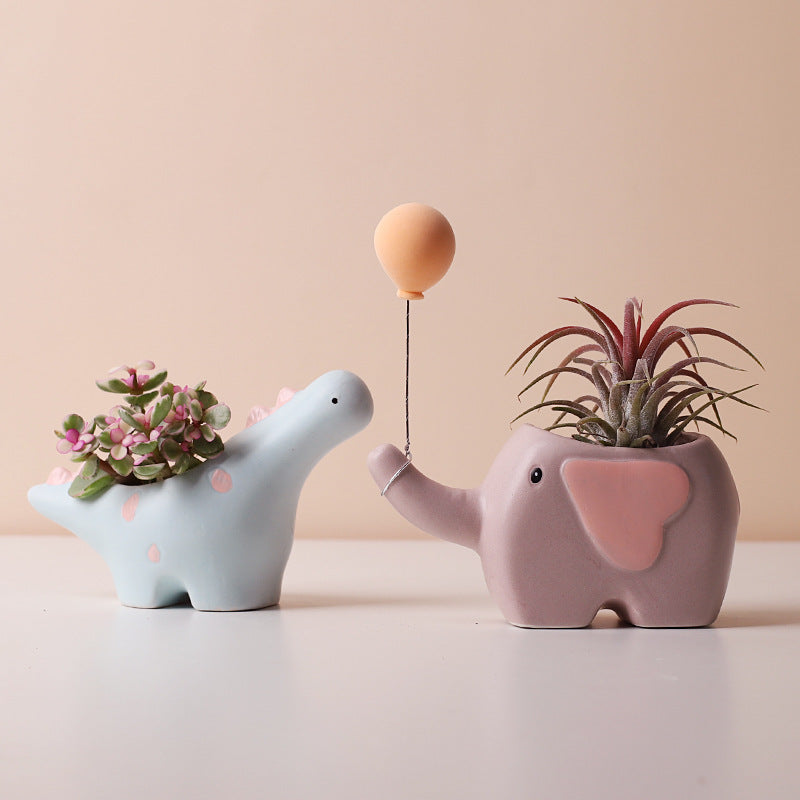 Cute ceramic succulent pot with elephant, dinosaur, and flower designs, ideal for desk, shelf, or balcony décor. Cavira brand.