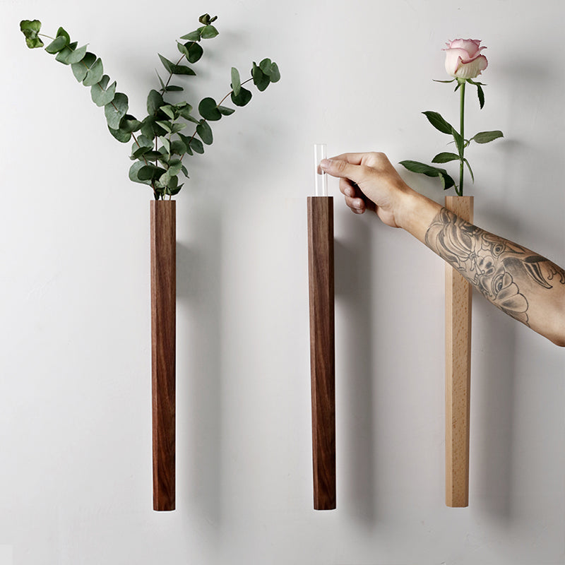 Cavira solid wood wall hanging vase with glass insert for hydroponic flowers, suitable for living room or bedroom decor.