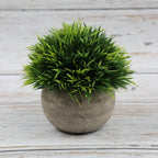 Artificial bonsai desktop plant in a semi-round pulp pot with faux grass and botanical arrangement, ideal for home or office decor.