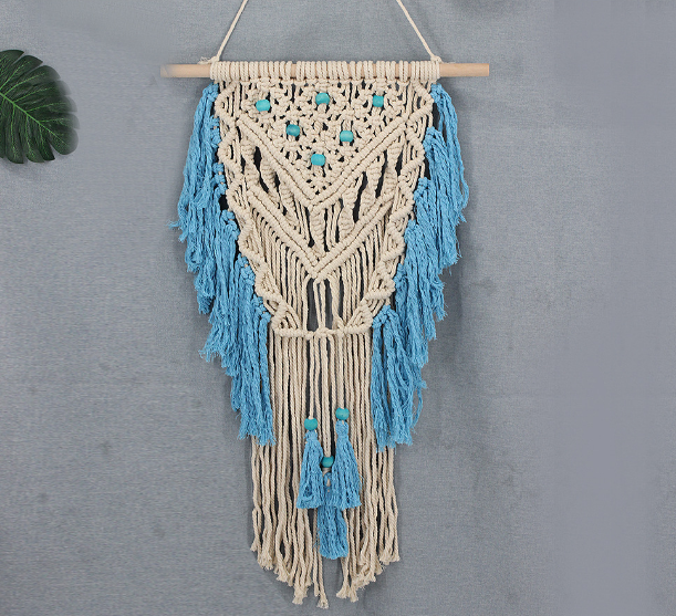 Blue bohemian hand-knotted macramé wall tapestry with cotton tassels and wooden stick for home or wedding décor.