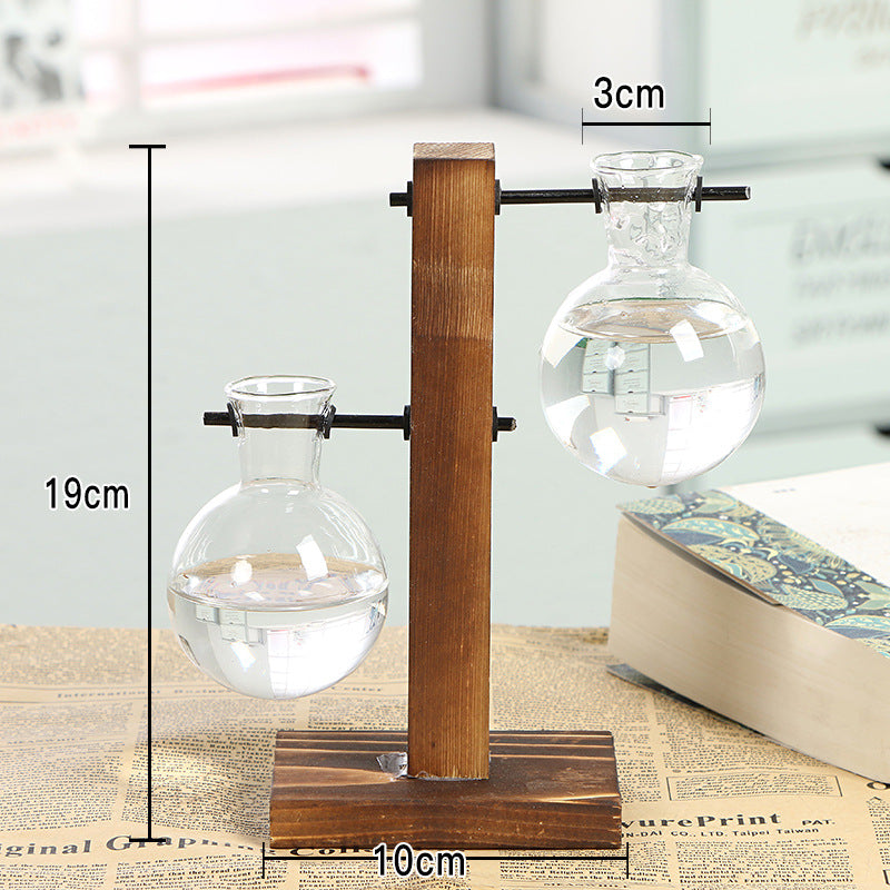 Minimalist glass bottle vase with wooden frame, transparent desktop flower vase for home decor and shelf styling by Cavira