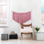 Pink bohemian cotton woven wall tapestry by Cavira, featuring a hanging basket weave design, ideal for bedroom decor or wedding backgrounds.