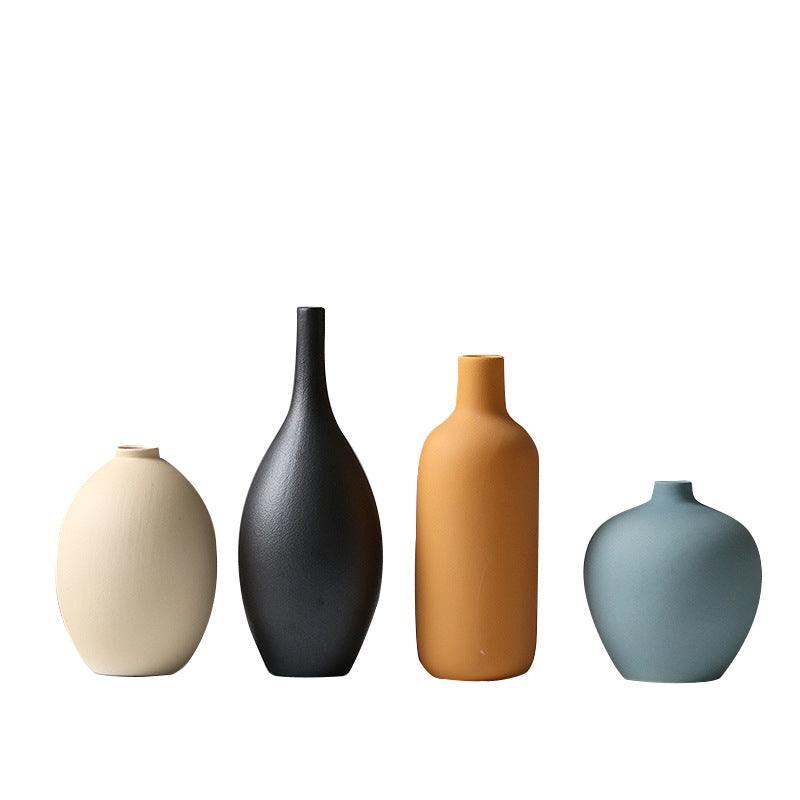 Set of four white porcelain ceramic vases by Cavira, modern minimalist design for flower arrangements and home decor.