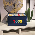 Cavira canvas folding dinosaur storage basket with embroidered cartoon dinosaur, ideal for kids' toys and stationery in bedroom or nursery