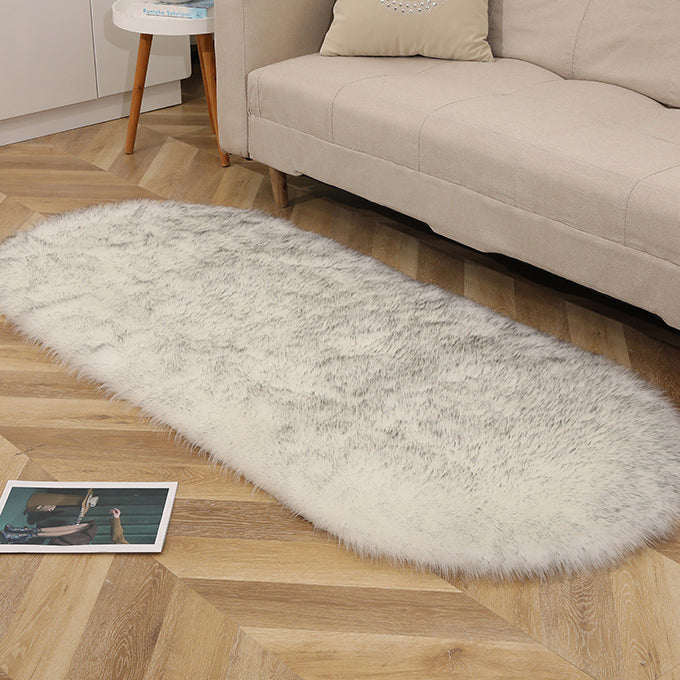 Oval acrylic plush rug by Cavira with soft wool-like pile in various sizes and colors, ideal for bedroom, living room, or bedside.