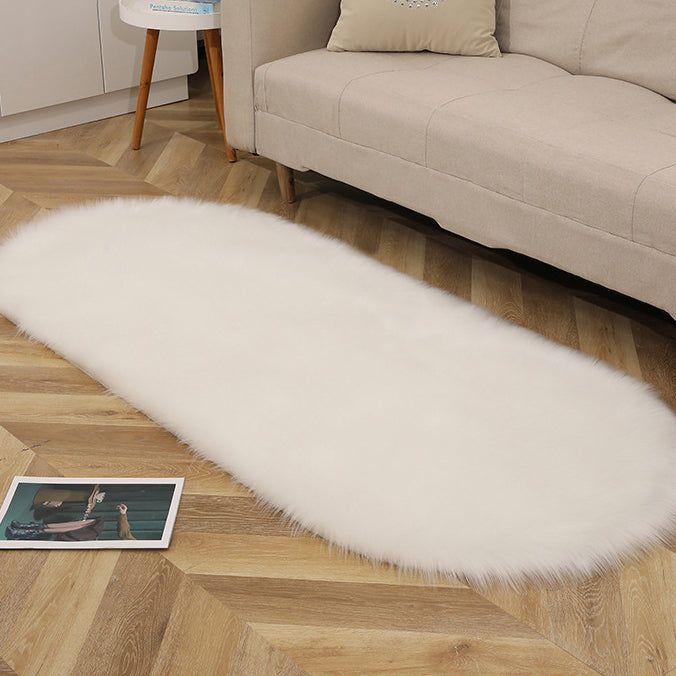 Oval acrylic plush rug by Cavira with soft wool pile, available in 14 colors and four sizes, ideal for bedroom or living room.
