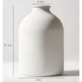 White matte metal vase with unique sculptural shape for dried flowers, ideal for home or wedding décor, shown with pampas grass.
