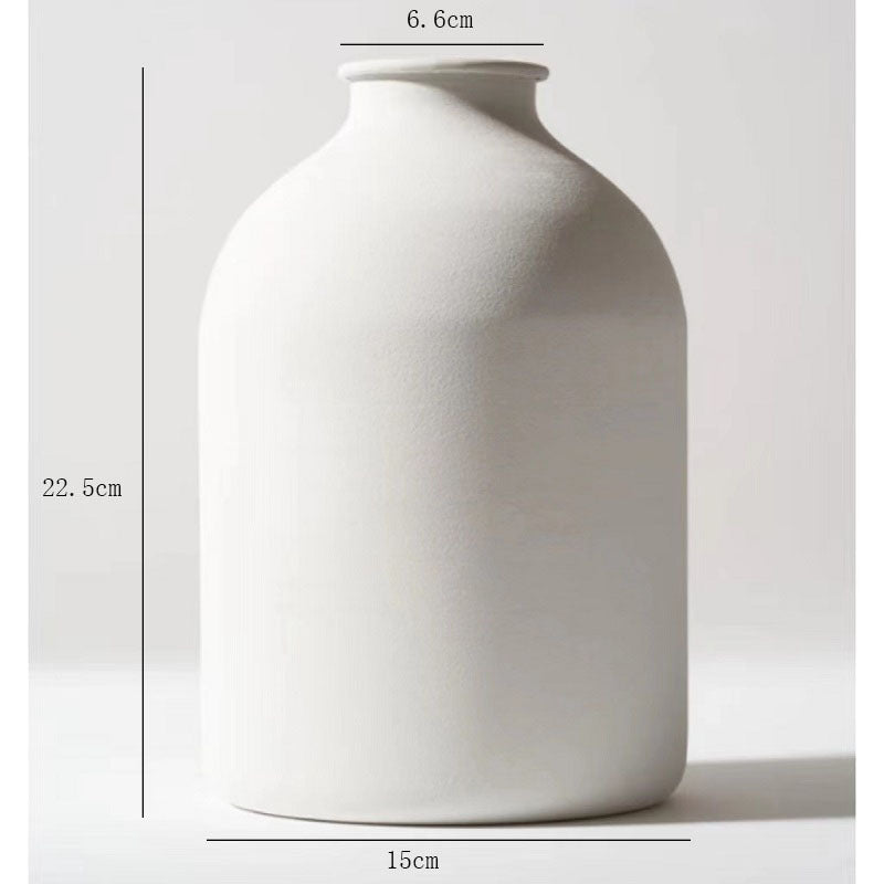 White matte metal vase with unique sculptural shape for dried flowers, ideal for home or wedding décor, shown with pampas grass.