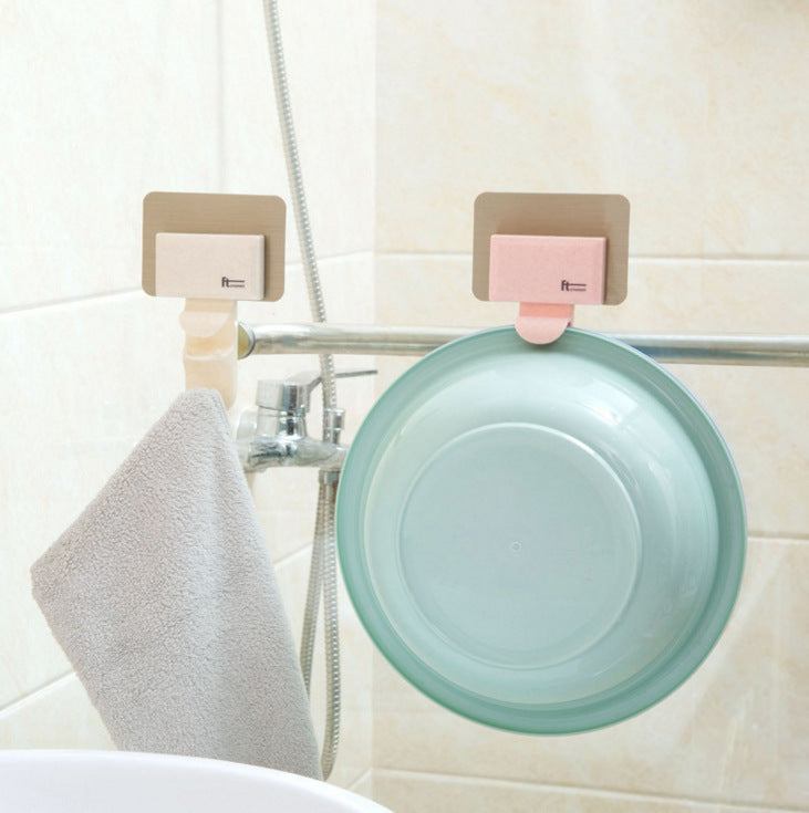 Pink and beige Cavira seamless wall-mounted washbasin hook rack made of ABS, punch-free bathroom basin hanger with multiple hooks.