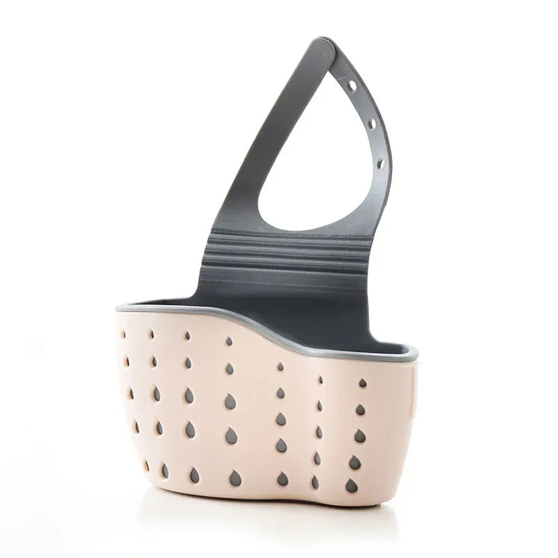 A handy kitchen accessory as sink drainer, multi - functional organizer for countertop dishes, sponges. Pink