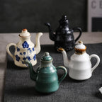 Cavira ceramic oil and vinegar dispenser bottle with auto-open lid in blue, white, or black, for soy sauce, oil, and condiments.