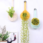 Handwoven boho cotton rope wall hanging net basket with woven flower design, used for storage or decor in home, bedroom, or living room.
