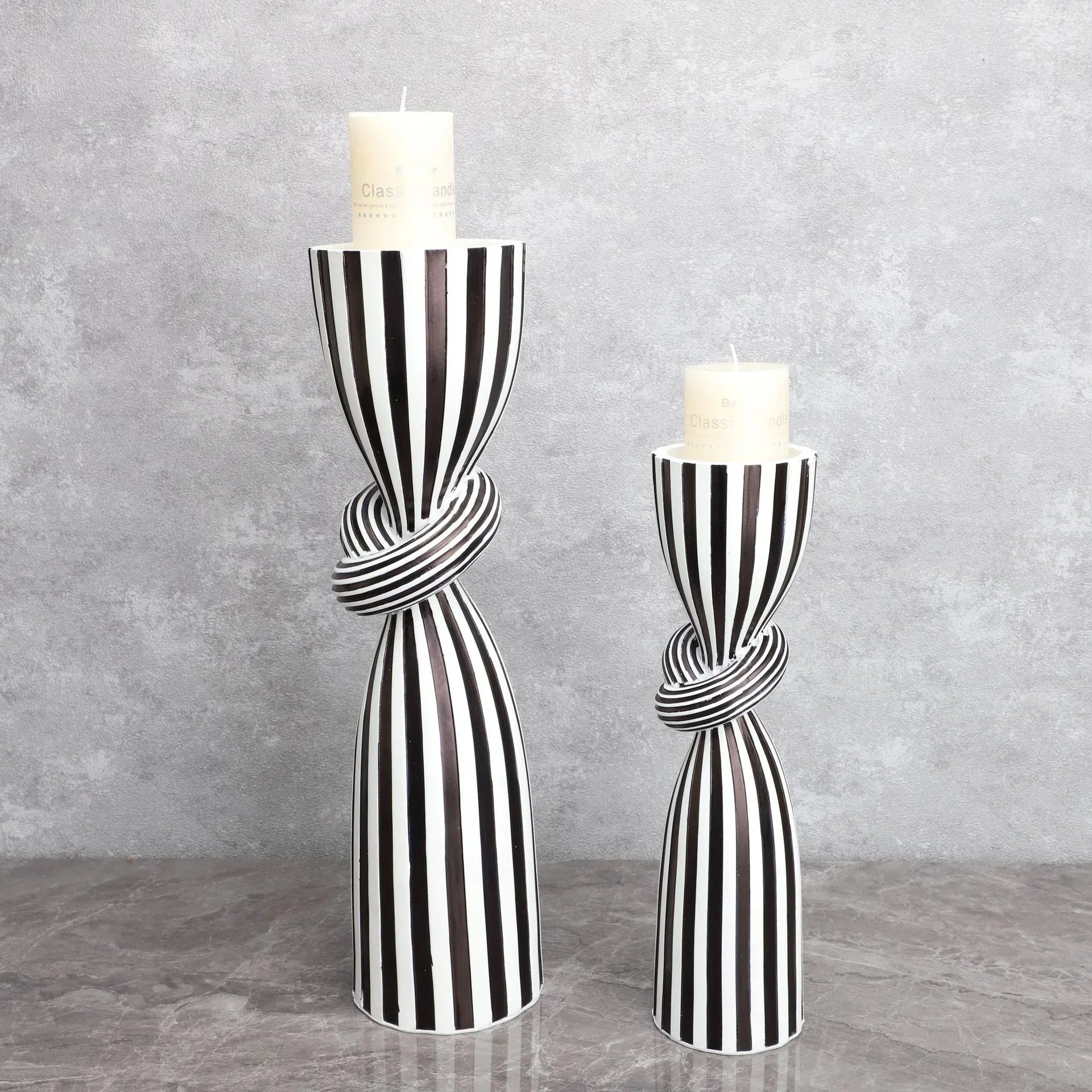 Black and white striped resin candle holder with modern irregular geometric design, perfect for home decor.