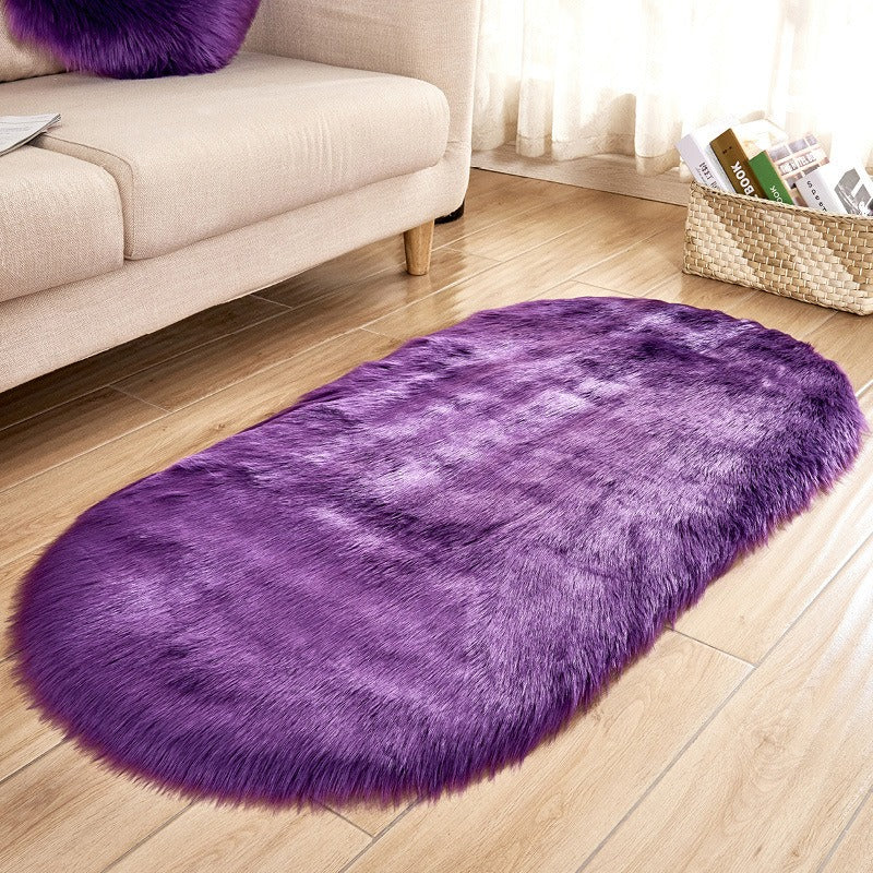 Oval acrylic plush rug by Cavira with soft wool pile in various colors, ideal for bedroom, living room, or bedside use.