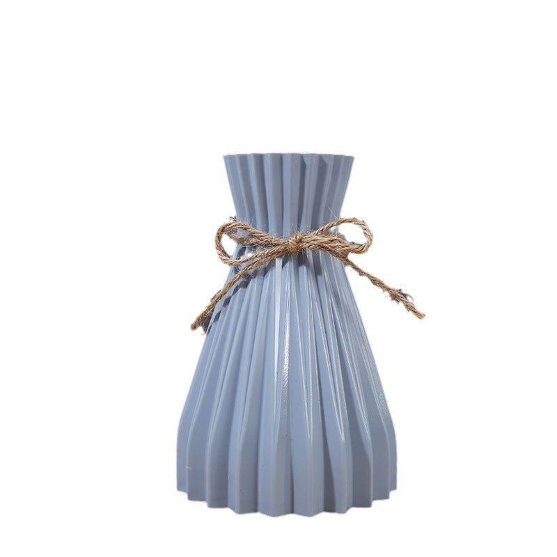 Cavira minimalist folded paper vase with twine detail, designed for creative plastic flower arrangements, ideal for home decor.