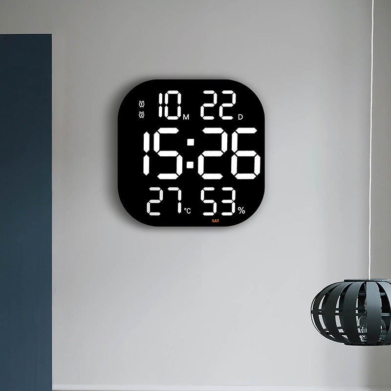 Cavira LED acrylic smart wall clock with digital display, thermometer, alarm, countdown, and night light in a modern living room setting